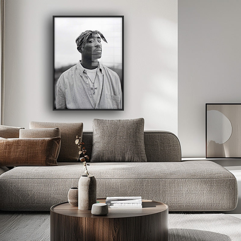 Painting of tupac in a black frame inside