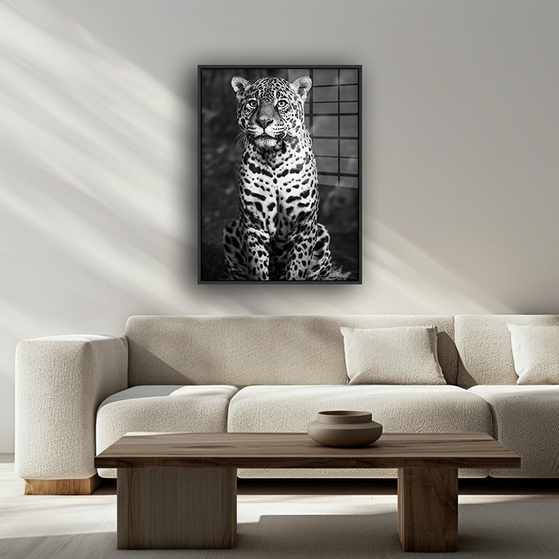 Painting of black & white leopard in a black frame inside